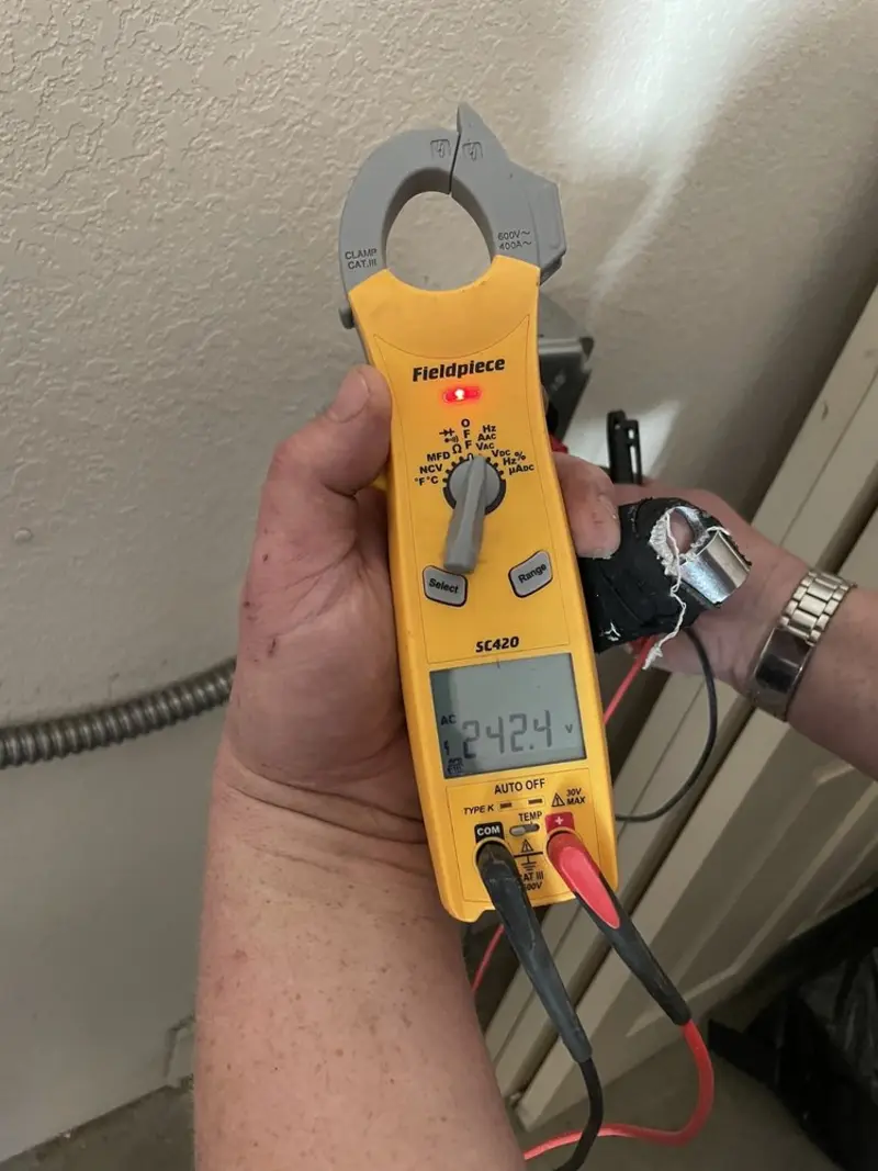 Voltage testing with clamp meter during Outlet Installation in Morada